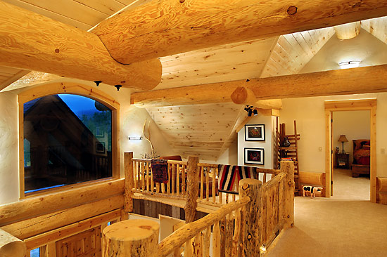 Exposed log ridges and log purlins in this handcrafted log home