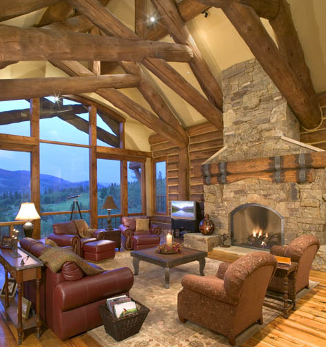 Hybrid log house with a row of log scissor trusses and a very unique log mantle