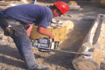chainsaw cutting V groove for a handcrafted log home