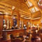 Large log siding with chinking is featured above this custom lounge in Earl's Lodge