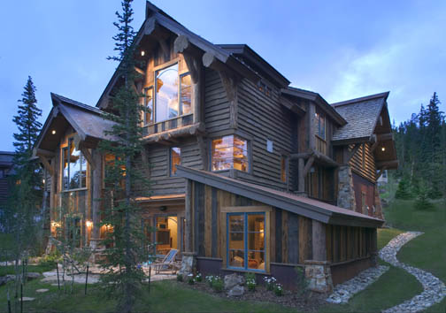 Log accents blend with a variety of finishes for a rustic look to this hybrid log house in the mountains of Colorado.